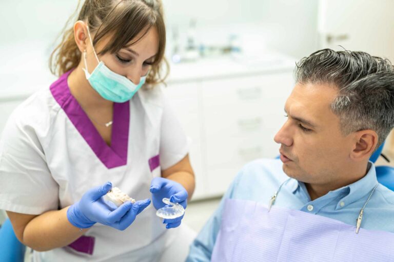 01 Dentist showing a dental splint to a patient in the clinic