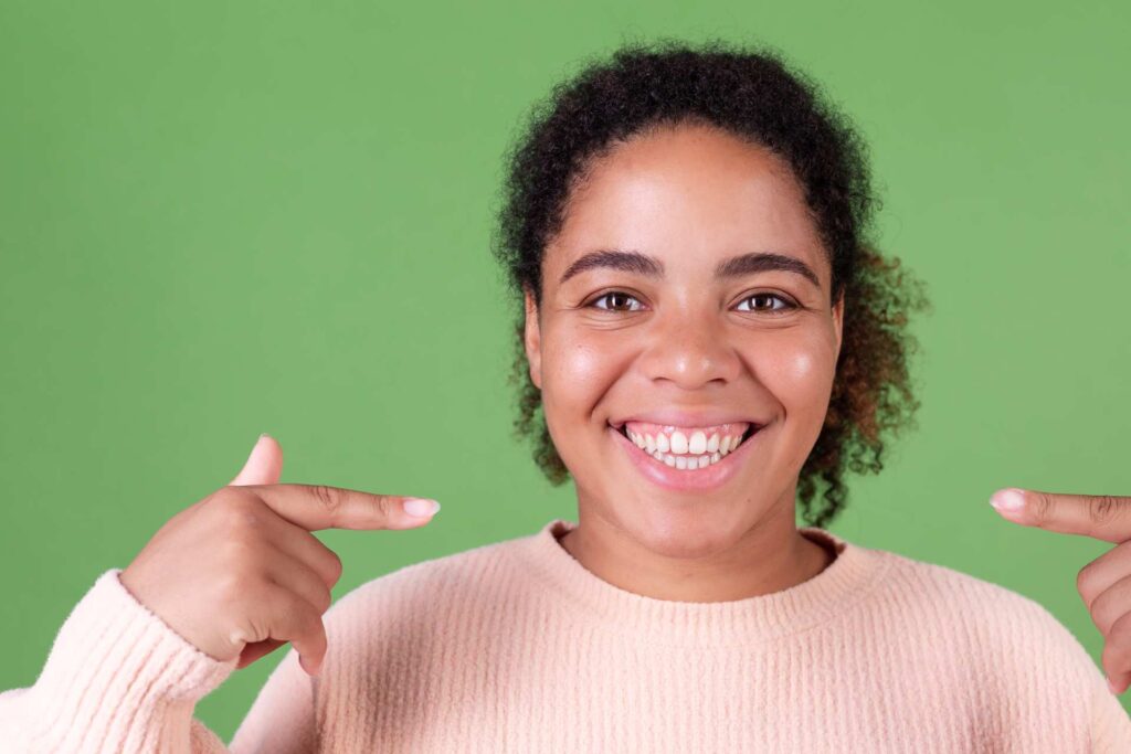 04 Young woman with sweater or pullover showing her broad smile