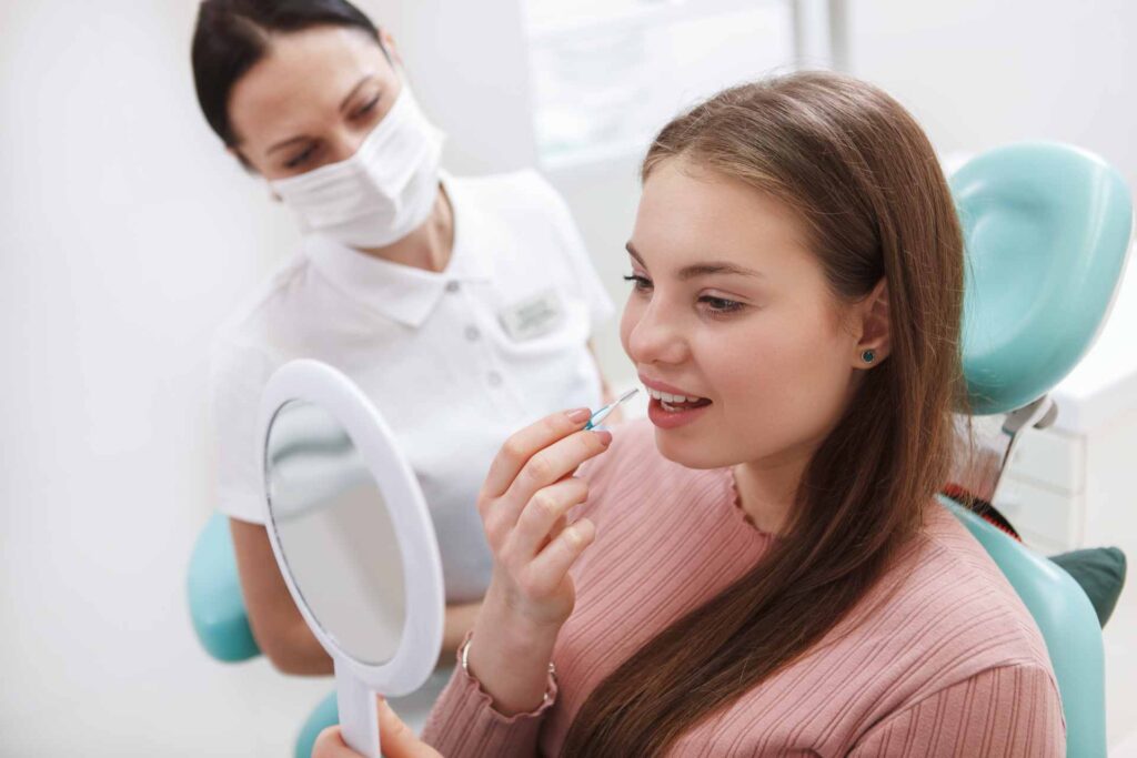 07 Young woman with her dentist choosing the best size interdental brush for her teeth