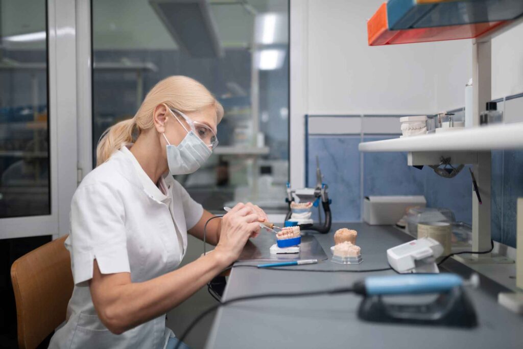 08 A dental technician fabricating porcelain dental veneers in a dental laboratory