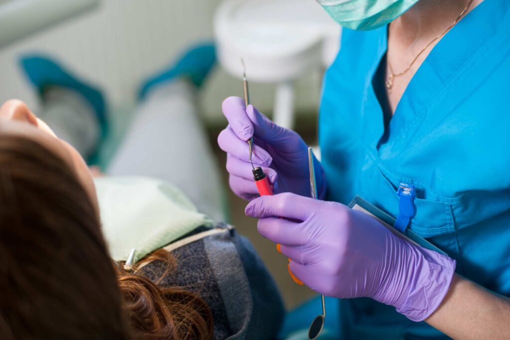 02 Dentist preparing the composite to apply veneers to a patient_Do porcelain veneers break easily - composite veneers vs. porcelain veneers