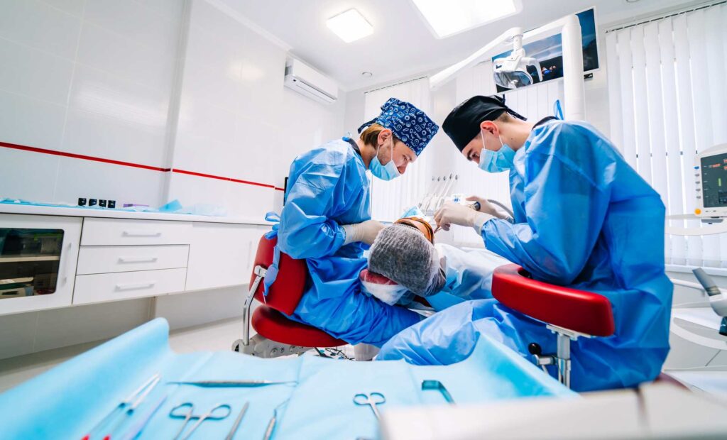 05 Patient during dental treatment in a clinic with two dentists_Do dental implants hurt